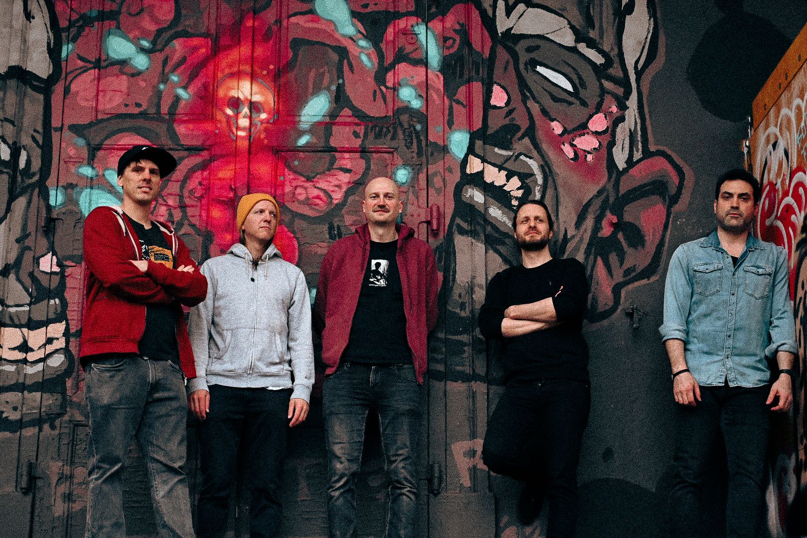 the band in front of a graffiti wall